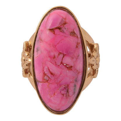 Ring with a pink stone and gold setting on a white background