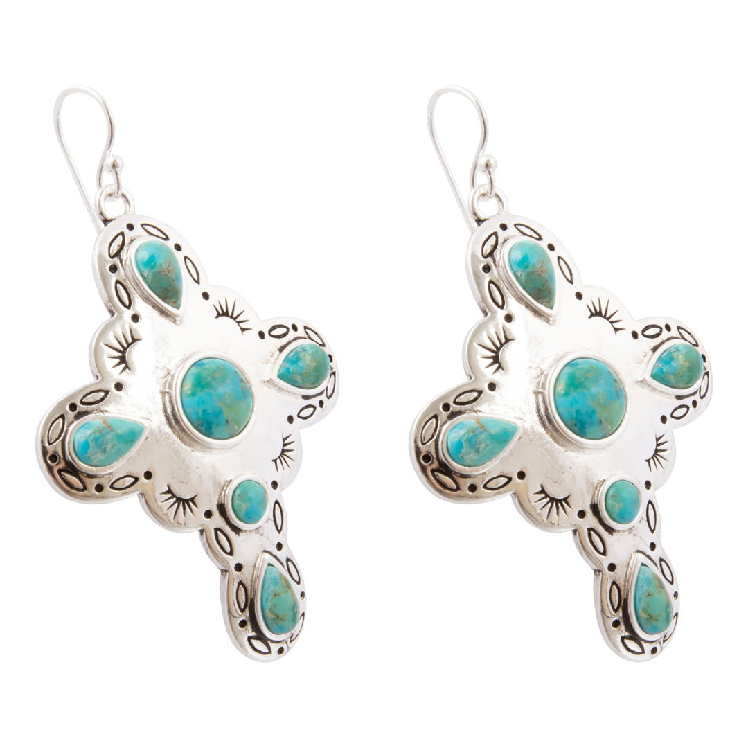 A pair of silver cross dangle earrings with turquoise stones, shown against a plain white background.