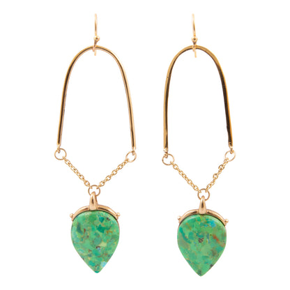 Gold hoop earrings with green teardrop stones on a white background