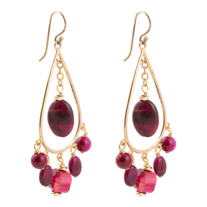 A pair of gold teardrop dangle earrings featuring a large oval dark magenta bead and smaller dangling beads in matching magenta and deep purple tones, set against a plain white background.