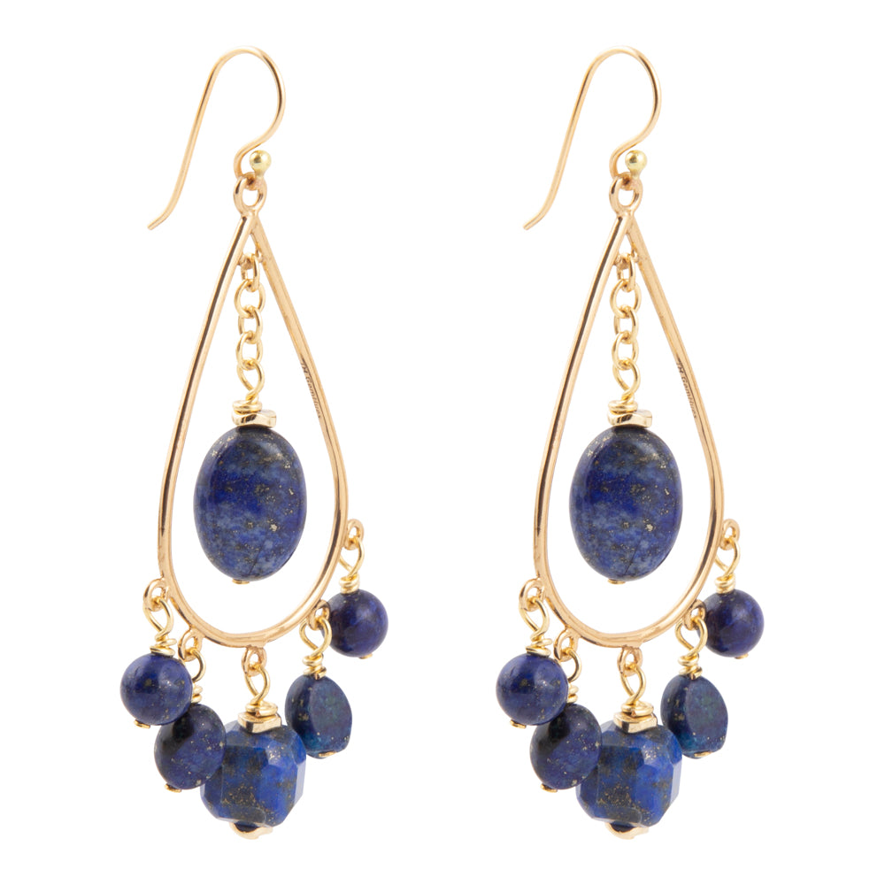 A pair of gold-tone dangle earrings featuring oval and round deep blue lapis lazuli stones, shown against a plain white background.