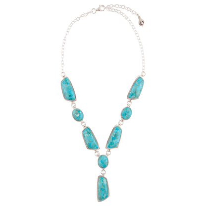 Turquoise necklace with silver chain on a white background