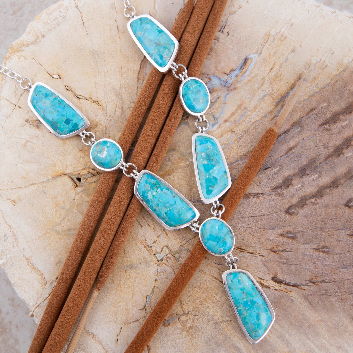 Necklace with turquoise stone pendants on a stone surface