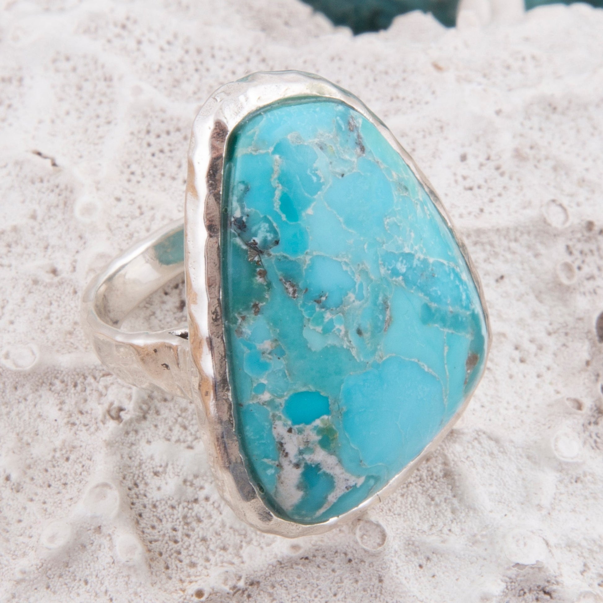 Turquoise stone ring on a textured surface