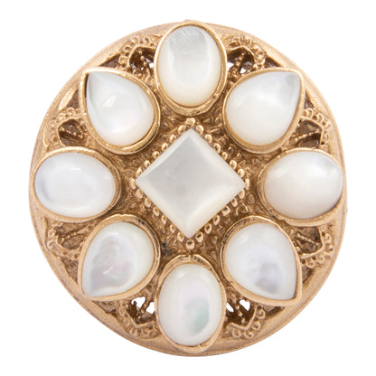 Decorative button with gold frame and white stones on a white background