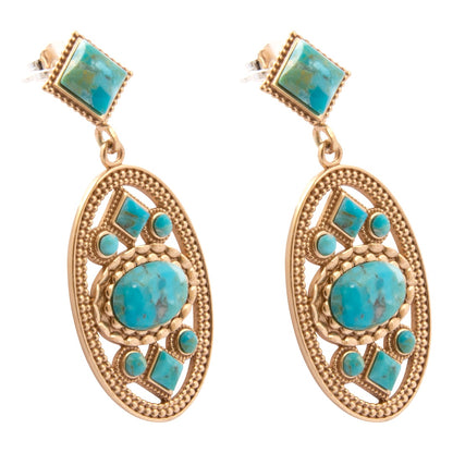 A pair of gold and turquoise drop earrings with a square stud top and an ornate oval dangle featuring a large central turquoise stone and smaller matching turquoise accents set in textured gold.