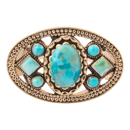 An oval turquoise and gold-toned jewelry piece, likely a brooch or belt buckle, featuring a large central turquoise cabochon and four smaller turquoise stones set in an ornate gold-toned metal frame.