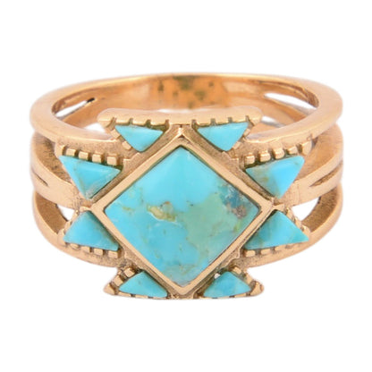 Gold ring with turquoise stones on a white background
