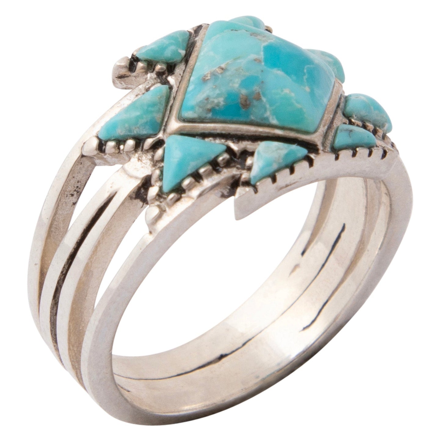 Silver ring with turquoise stones on a white background