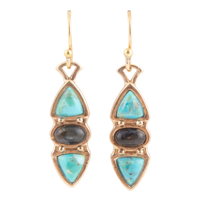 A pair of gold drop earrings featuring light blue turquoise stones, a dark gray stone in the middle, and a smaller light blue stone at the bottom, set in gold-tone metal on a white background.