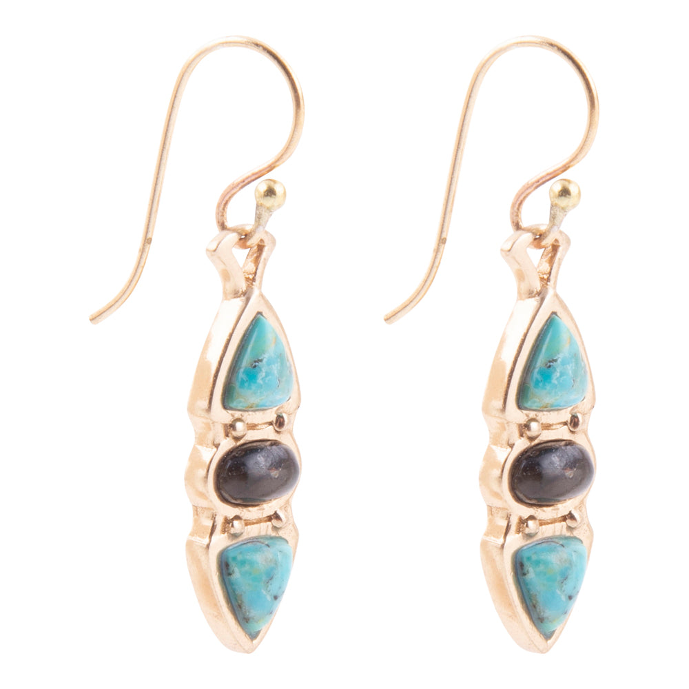 A pair of gold drop earrings featuring light blue turquoise stones and a central dark gray stone, shown on a plain white background.