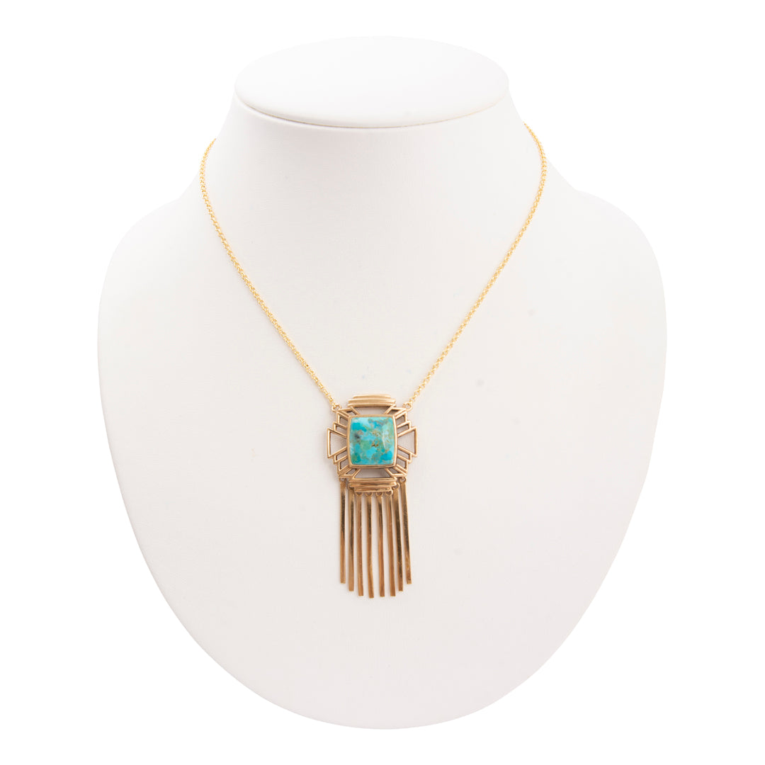 Necklace with a turquoise pendant on a white mannequin bust