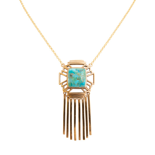 Gold necklace with a turquoise pendant on a white background