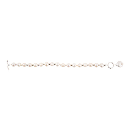A delicate bracelet featuring small, round white pearls strung on a silver-toned metal chain with a lobster clasp, shown against a plain white background.