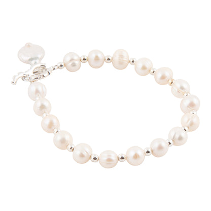 A pearl beaded bracelet with silver spacer beads and a silver clasp, shown on a plain white background.