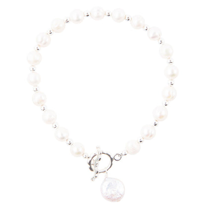 A beaded bracelet featuring white freshwater pearls separated by small silver spacer beads, finished with a silver toggle clasp and a dangling round white pearl charm.