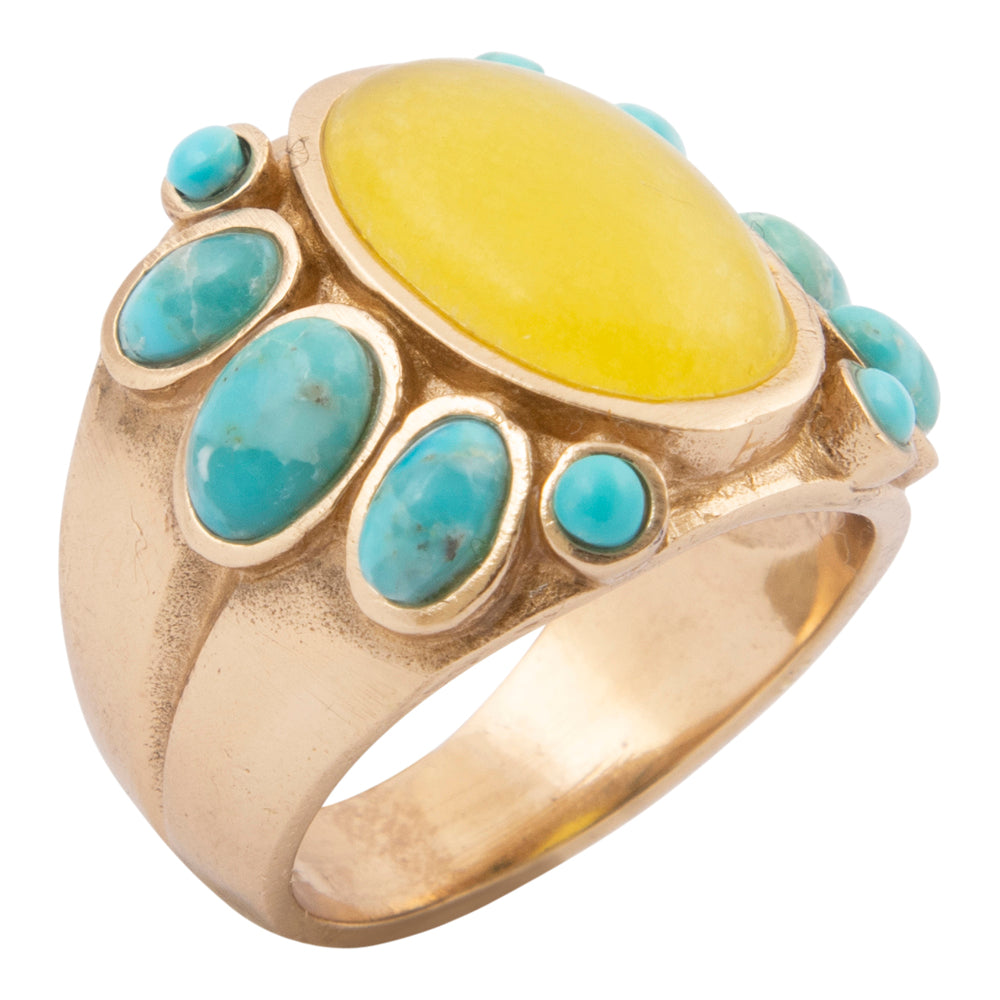 Gold ring with a yellow stone and turquoise stones on a white background