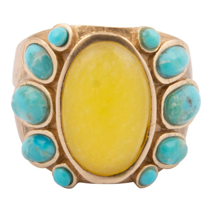 Ring with yellow stone and turquoise stones on a white background