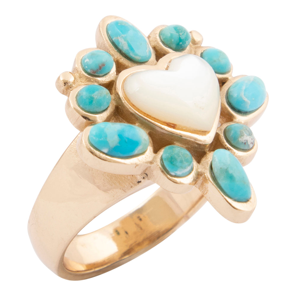 Gold ring with turquoise stones and a white heart-shaped center on a white background