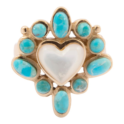 Heart-shaped ring with turquoise stones on a white background