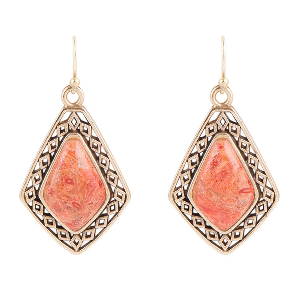 Pair of earrings with pink stone and gold frame on a white background