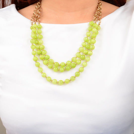 Necklace with green beads on a white background