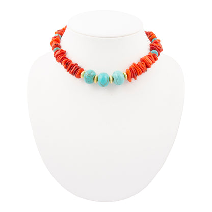 Necklace with orange and turquoise beads on a white mannequin.