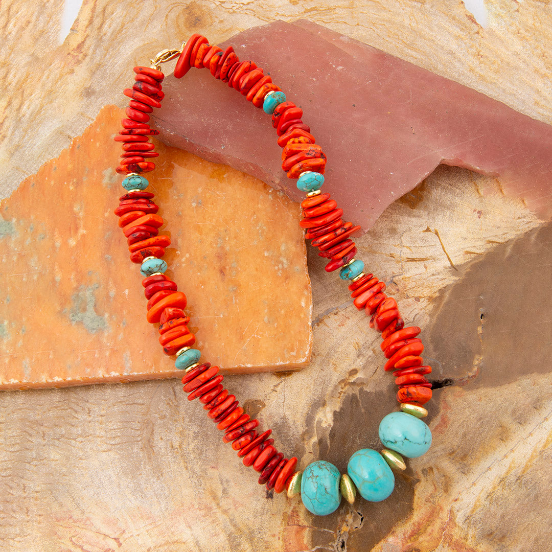 Bracelet with red and turquoise beads on a stone surface
