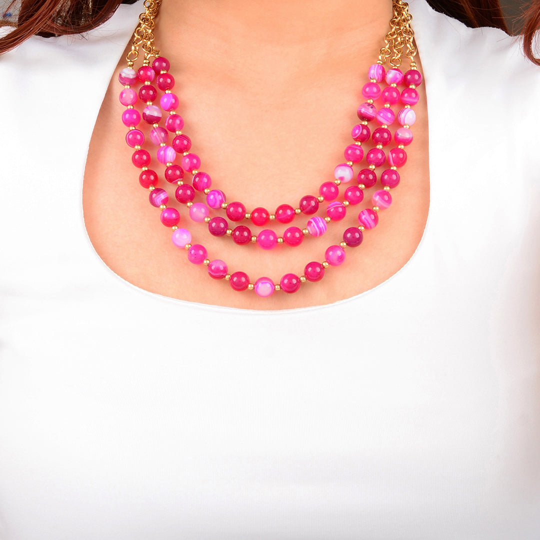 Necklace with pink and purple beads on a white background