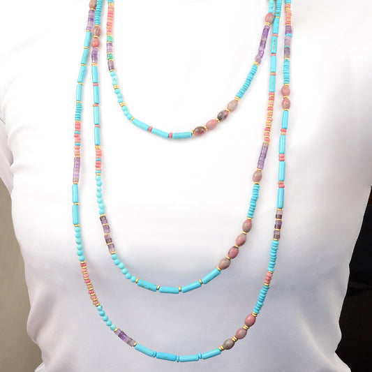 Colorful beaded necklace on a mannequin with a plain background