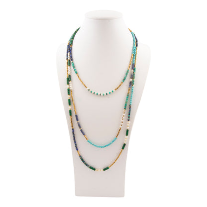 Multistrand beaded necklace on a mannequin bust against a white background