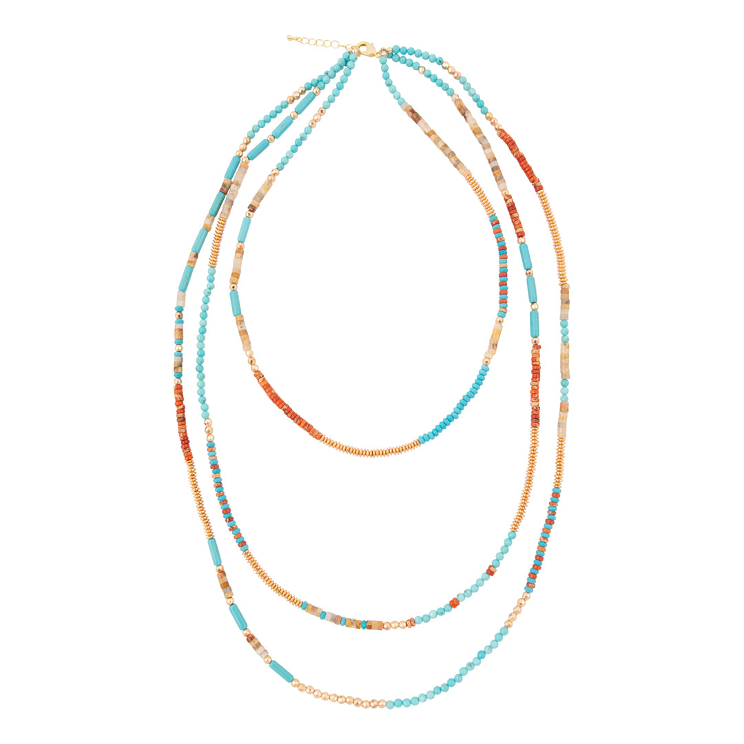 Multistrand beaded necklace with blue and orange beads on a white background