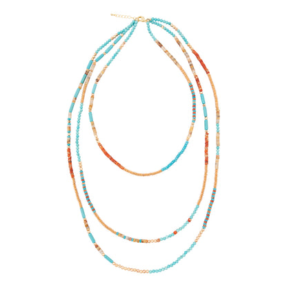 Multistrand beaded necklace with blue and orange beads on a white background