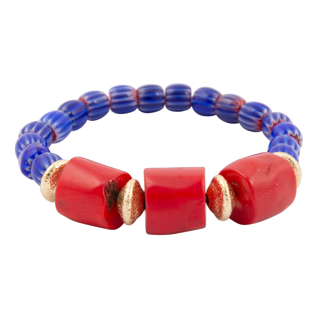 Bracelet with blue beads and red cylindrical beads on a white background