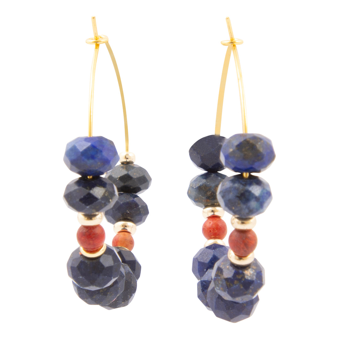 Pair of earrings with blue and red beads on a white background