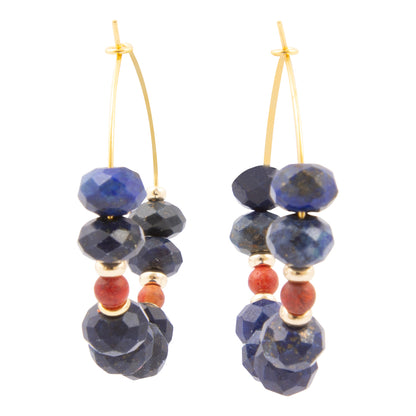 Pair of earrings with blue and red beads on a white background