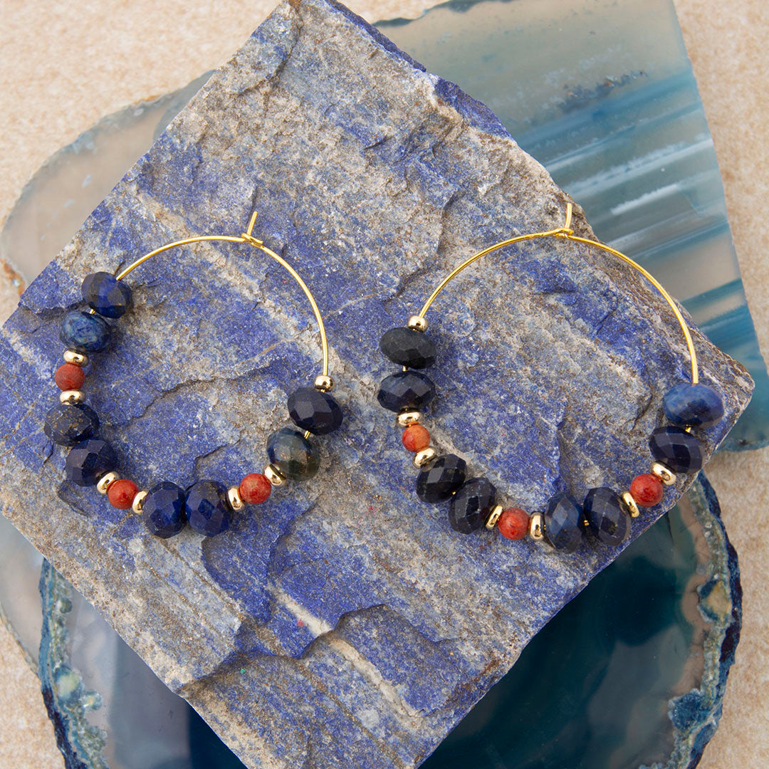 Pair of hoop earrings with blue and red beads on a lapis lazuli stone