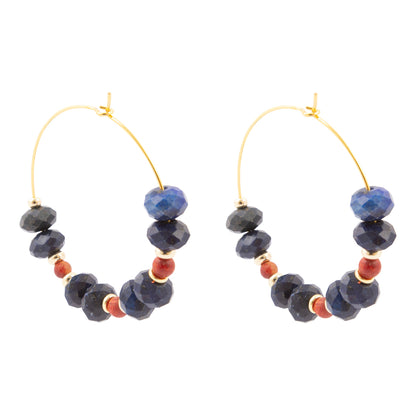 Pair of hoop earrings with blue and red beads on a white background