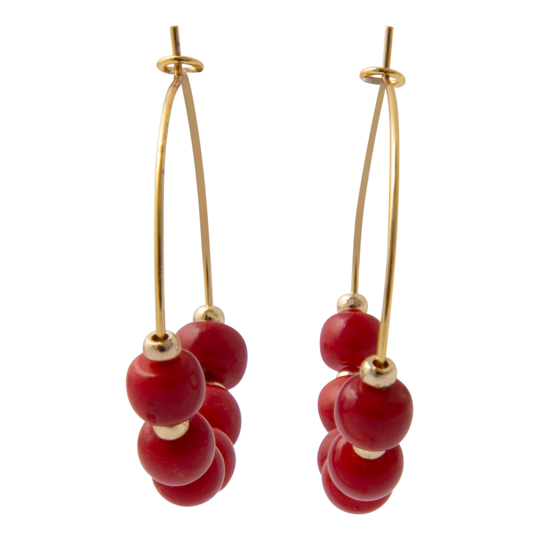 Pair of red beaded earrings with gold hooks on a white background
