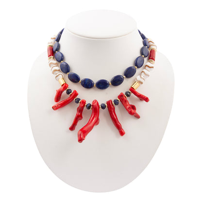 Necklace with red, blue, and gold beads on a white stand