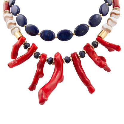 Necklace with red coral and blue beads on a white background