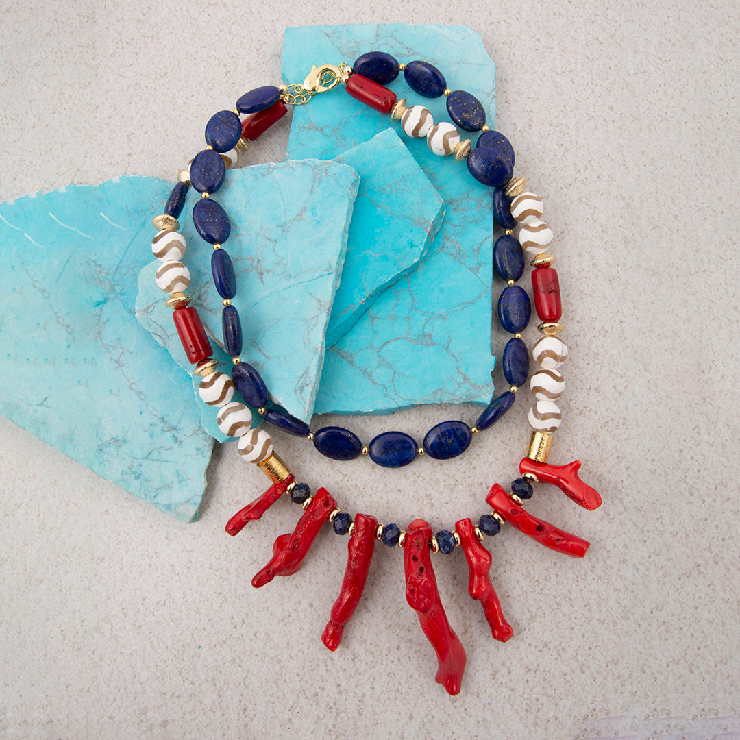 Necklace with red, blue, and white beads on a textured surface