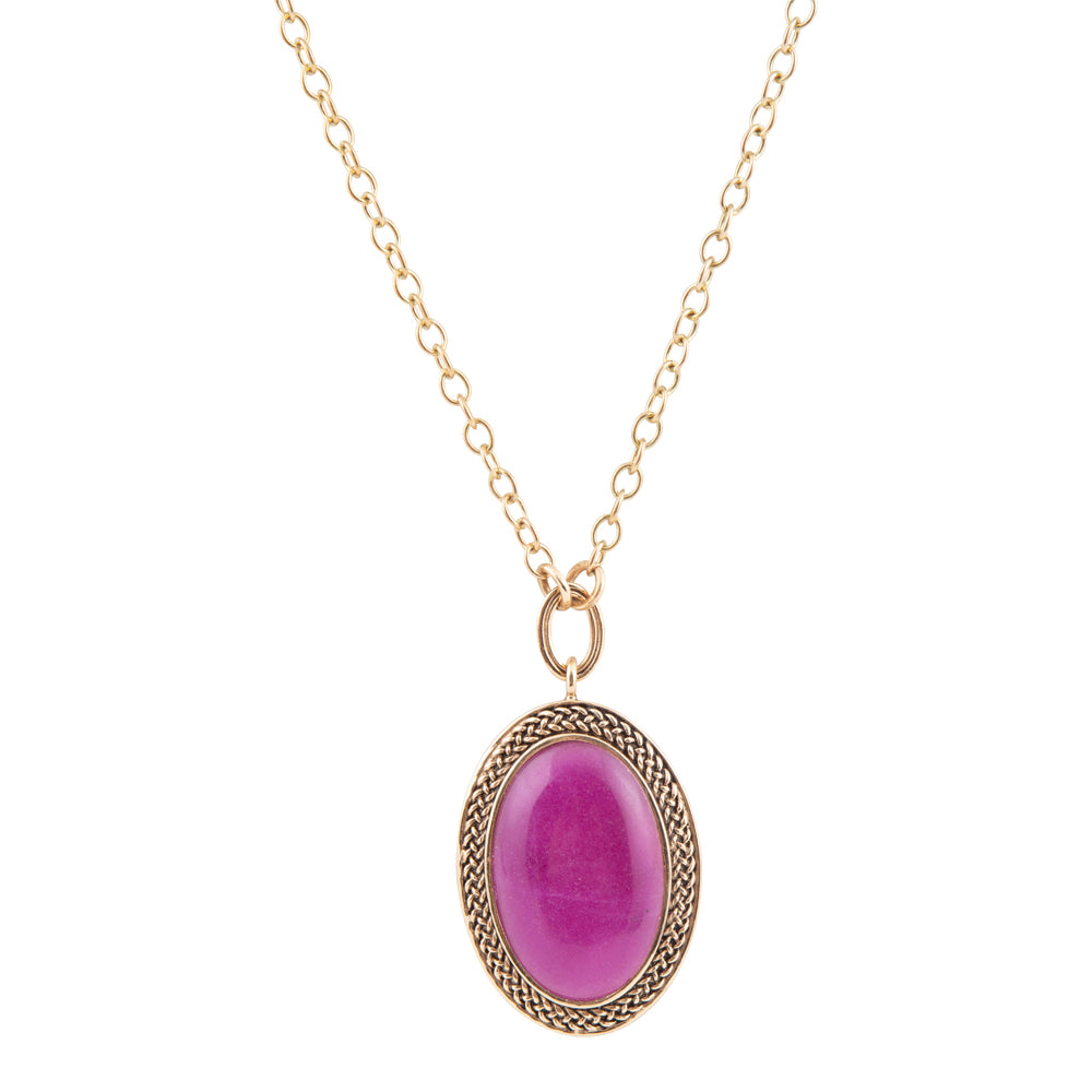 Teardrop-shaped pendant with blue and brown gemstones on a white background
