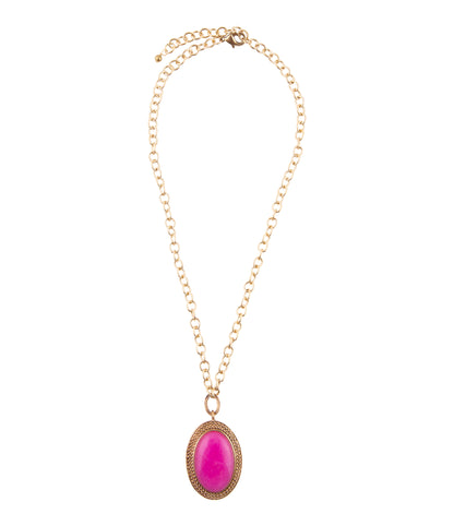 A gold chain necklace with an oval pendant featuring a bright pink cabochon stone surrounded by a textured gold border, shown on a plain white background.