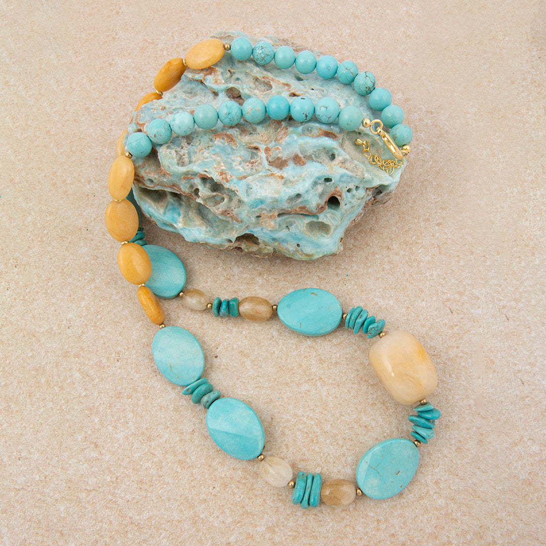 Necklace with turquoise and beige beads on a textured surface