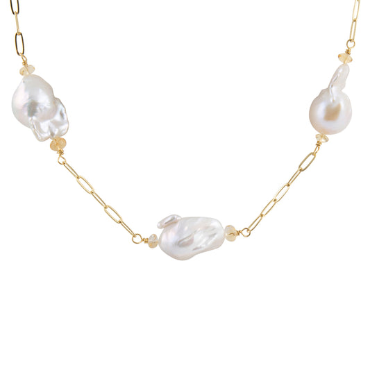 A gold chain necklace featuring three large, irregular baroque-style white pearls spaced along the chain, accented with small gold beads, shown on a plain white background.