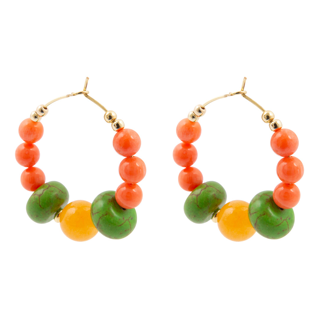 Pair of hoop earrings with orange and green beads on a white background