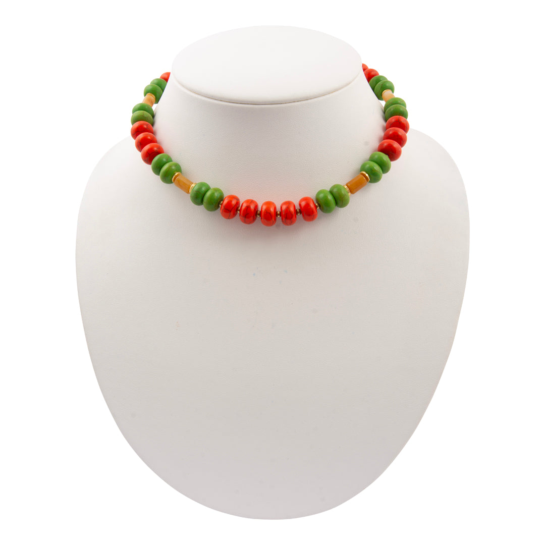 Necklace with green, red, and brown beads on a white background