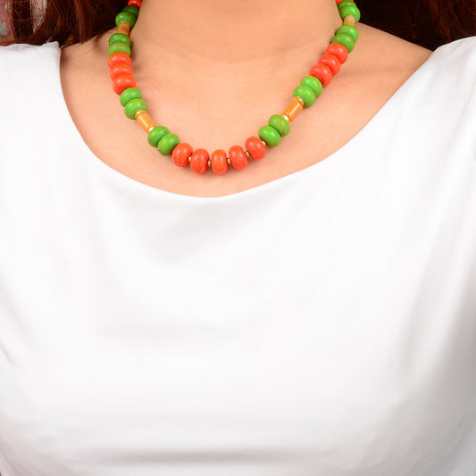 Necklace with green, red, and brown beads on a white background