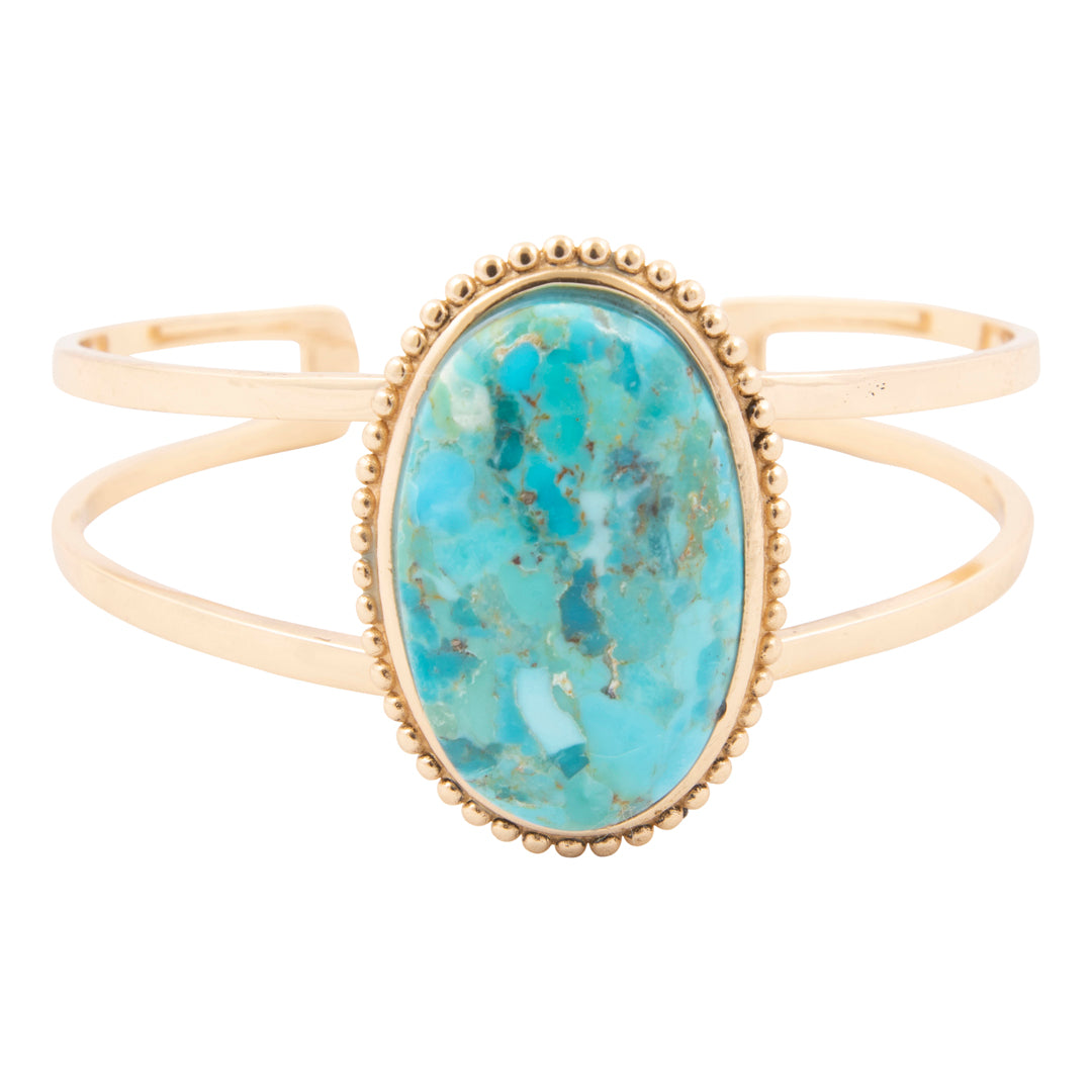 Gold bracelet with a turquoise stone on a white background